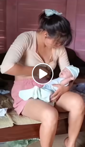 Cute Nurse Breastfeeds A Baby